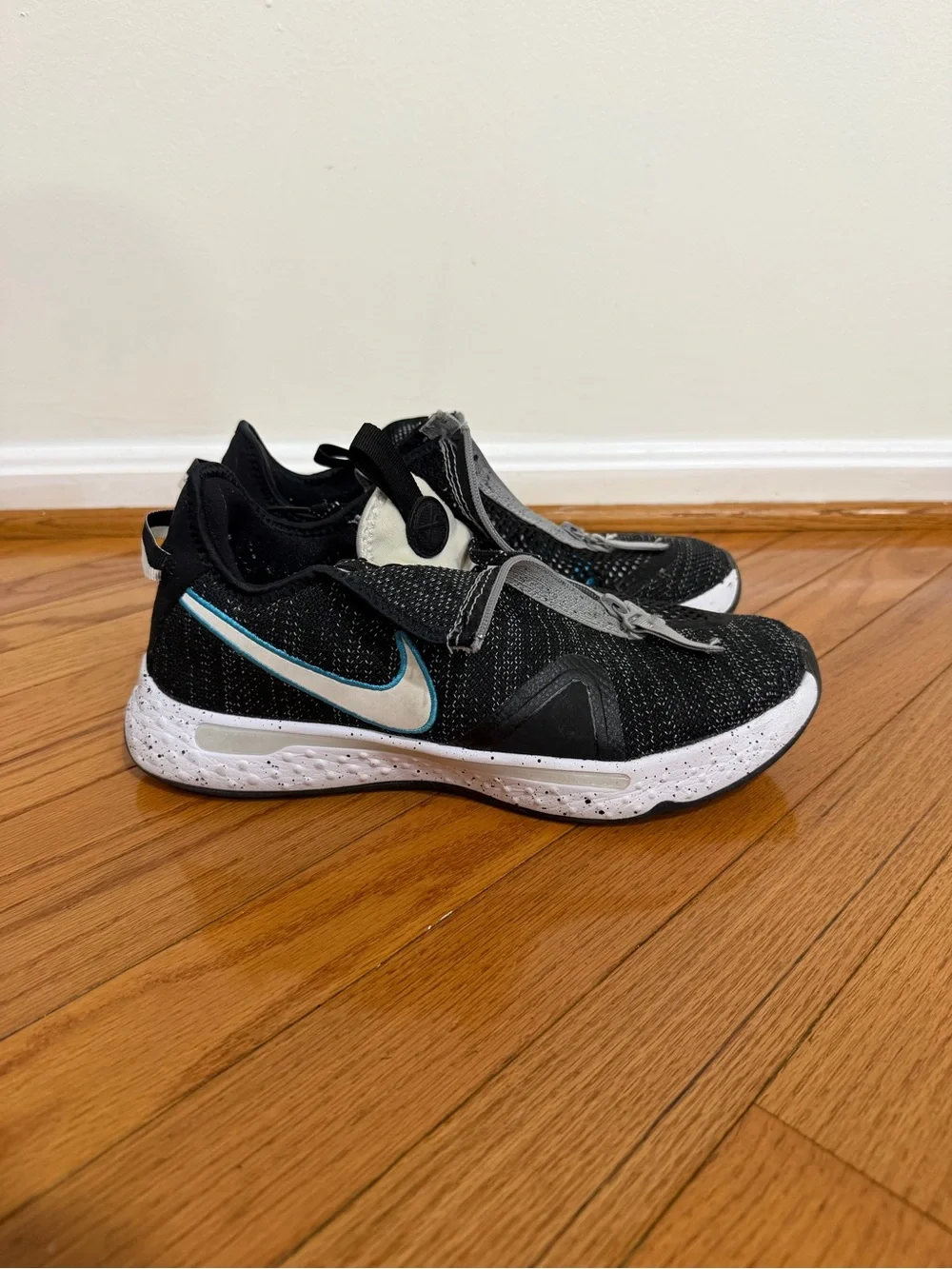 Nike Men’s Paul George 4 Black and White Sneakers with Teal Swoosh